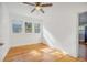 This simple bedroom features hardwood floors, a ceiling fan, and decorative windows at 934 N Halifax Ave, Daytona Beach, FL 32118