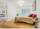 Well-lit bedroom with hardwood floors, a comfortable bed, and sliding glass doors at 934 N Halifax Ave, Daytona Beach, FL 32118