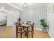 Charming dining room featuring decorative wallpaper, hardwood floors, and modern decor at 934 N Halifax Ave, Daytona Beach, FL 32118