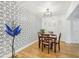 Charming dining room featuring decorative wallpaper, hardwood floors, and a modern chandelier at 934 N Halifax Ave, Daytona Beach, FL 32118