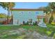 Charming two-story home features a welcoming front entrance and lush landscaping at 934 N Halifax Ave, Daytona Beach, FL 32118