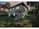 Charming two-story home featuring lush landscaping and mature palm trees at 934 N Halifax Ave, Daytona Beach, FL 32118