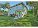 Charming home featuring a welcoming front porch and well-maintained lawn with tropical landscaping and mature palm trees at 934 N Halifax Ave, Daytona Beach, FL 32118