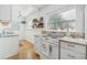 Well-lit kitchen featuring white cabinets, stone counter tops, and modern appliances at 934 N Halifax Ave, Daytona Beach, FL 32118