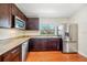 Modern kitchen with stainless steel appliances, granite counters, and dark wood cabinets at 934 N Halifax Ave, Daytona Beach, FL 32118