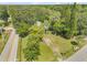 Aerial view of the property surrounded by lush greenery at 102 N Brooks Cir, Oak Hill, FL 32759