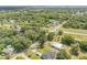 Scenic aerial shot of a property surrounded by trees in a quiet, peaceful community with railroad access at 102 N Brooks Cir, Oak Hill, FL 32759