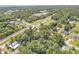 Areal view of a verdant neighborhood and railroad tracks running through the tranquil community at 102 N Brooks Cir, Oak Hill, FL 32759