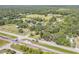 Expansive aerial view showing the property surrounded by lush greenery and a tranquil neighborhood at 102 N Brooks Cir, Oak Hill, FL 32759