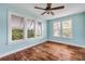 Bedroom with lots of natural light and ceiling fan at 102 N Brooks Cir, Oak Hill, FL 32759