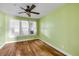 Bedroom with hardwood floors and natural light at 102 N Brooks Cir, Oak Hill, FL 32759