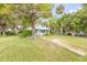 Charming home featuring lush landscaping and a welcoming front yard at 102 N Brooks Cir, Oak Hill, FL 32759