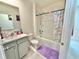 Bright bathroom featuring a tub with shower and a vanity with ample counter space at 103 Old Mill Pond Rd, Edgewater, FL 32141