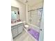 Bright bathroom featuring a tub with shower and a vanity with ample counter space at 103 Old Mill Pond Rd, Edgewater, FL 32141