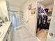 Bathroom showcasing double sinks, gray cabinets, tiled floors and a walk in closet at 103 Old Mill Pond Rd, Edgewater, FL 32141