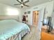 Well-lit bedroom with ceiling fan, and a glimpse into the bathroom creating a calm space at 103 Old Mill Pond Rd, Edgewater, FL 32141