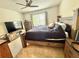 Inviting bedroom featuring a wooden bed frame, tv, dresser, nightstands, and carpet flooring at 103 Old Mill Pond Rd, Edgewater, FL 32141