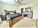 Comfortable bedroom with wooden bed frame, nightstand, and dresser with a fireplace at 103 Old Mill Pond Rd, Edgewater, FL 32141
