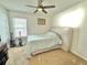 A bedroom with neutral carpet and a ceiling fan, offering comfort and functionality at 103 Old Mill Pond Rd, Edgewater, FL 32141