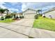 Well-maintained single-story home with a spacious driveway, lush lawn, and manicured landscaping at 103 Old Mill Pond Rd, Edgewater, FL 32141
