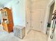 Inviting foyer with neutral tile flooring, storage cabinet and a glimpse of the door at 103 Old Mill Pond Rd, Edgewater, FL 32141