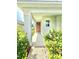 Inviting front porch featuring well-maintained landscaping and stylish front door at 103 Old Mill Pond Rd, Edgewater, FL 32141