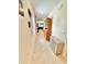 Bright hallway with neutral tile floors and stylish decor leading to living area at 103 Old Mill Pond Rd, Edgewater, FL 32141