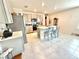 Bright eat-in kitchen featuring stainless steel appliances, gray cabinets, and tile floors at 103 Old Mill Pond Rd, Edgewater, FL 32141