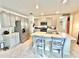 Well-lit eat-in kitchen with stainless steel appliances, ample cabinets, and tiled floors at 103 Old Mill Pond Rd, Edgewater, FL 32141