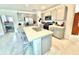 Well-lit eat-in kitchen with stainless steel appliances, gray cabinets, and tiled floors at 103 Old Mill Pond Rd, Edgewater, FL 32141