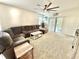 Spacious living room featuring a large sectional sofa and sliding glass doors to the outside at 103 Old Mill Pond Rd, Edgewater, FL 32141