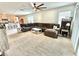 Open living area with a large sectional sofa that opens to a modern kitchen with an island at 103 Old Mill Pond Rd, Edgewater, FL 32141