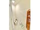 Compact powder room featuring a toilet and charming wooden shelving for storage at 103 Old Mill Pond Rd, Edgewater, FL 32141