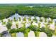 An aerial view of the home and neighborhood with a pond and trees nearby at 1221 Siesta Key Cir, Port Orange, FL 32128