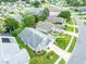 This aerial shows the light green house with a gray roof nestled among other homes in the community at 1221 Siesta Key Cir, Port Orange, FL 32128