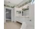 Bright bathroom featuring double sinks, soaking tub, and decorative wallpaper trim at 1221 Siesta Key Cir, Port Orange, FL 32128