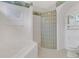 Corner view of a bathroom featuring a soaking tub and decorative glass block wall and border at 1221 Siesta Key Cir, Port Orange, FL 32128