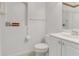 Clean bathroom with white vanity, toilet, framed art and decorative floral wallpaper trim at 1221 Siesta Key Cir, Port Orange, FL 32128