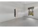 Bright bedroom with neutral carpeting, open doorway, and window with floral curtains at 1221 Siesta Key Cir, Port Orange, FL 32128