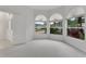 Bright bedroom with arched windows providing views of the landscaped neighborhood at 1221 Siesta Key Cir, Port Orange, FL 32128