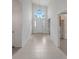 Light and bright foyer with tile flooring, high ceilings, and transom windows at 1221 Siesta Key Cir, Port Orange, FL 32128