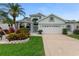 Charming home with arched windows, manicured lawn, and two car garage at 1221 Siesta Key Cir, Port Orange, FL 32128