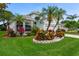 Well maintained lawn and beautiful Florida landscaping surrounds this home at 1221 Siesta Key Cir, Port Orange, FL 32128