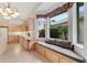Bright kitchen with cabinetry, tile floors, and cozy window bench seating at 1221 Siesta Key Cir, Port Orange, FL 32128