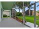 A screened-in lanai offers views of the lush landscaping and other homes in the neighborhood at 1221 Siesta Key Cir, Port Orange, FL 32128