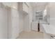 Bright laundry room featuring a washer, dryer, built-in cabinets, and neutral tile flooring at 1221 Siesta Key Cir, Port Orange, FL 32128