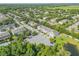Beautiful aerial view of the community with lush landscaping, pond, and ample parking spaces at 1453 River Rock Ct, Oviedo, FL 32765