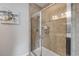 Bathroom shower with glass doors and neutral tiled walls in the main bathroom at 1453 River Rock Ct, Oviedo, FL 32765