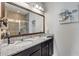Bathroom with dual sink vanity, granite countertop, and a large framed mirror at 1453 River Rock Ct, Oviedo, FL 32765
