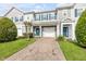 Inviting townhome with brick paver driveway, well-kept lawn, and a vibrant blue front door at 1453 River Rock Ct, Oviedo, FL 32765